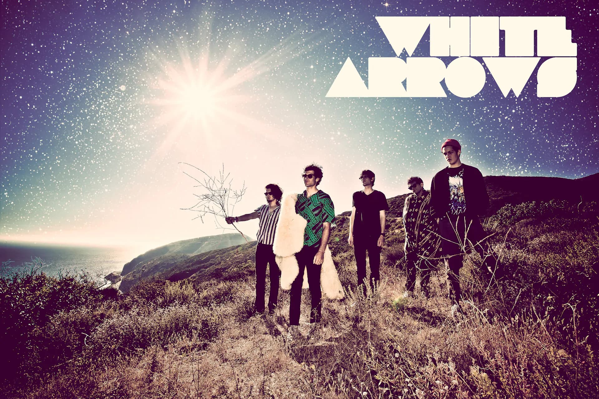 White Arrows promo artwork: the band at golden hour in the Malibu hills under the White Arrows logo